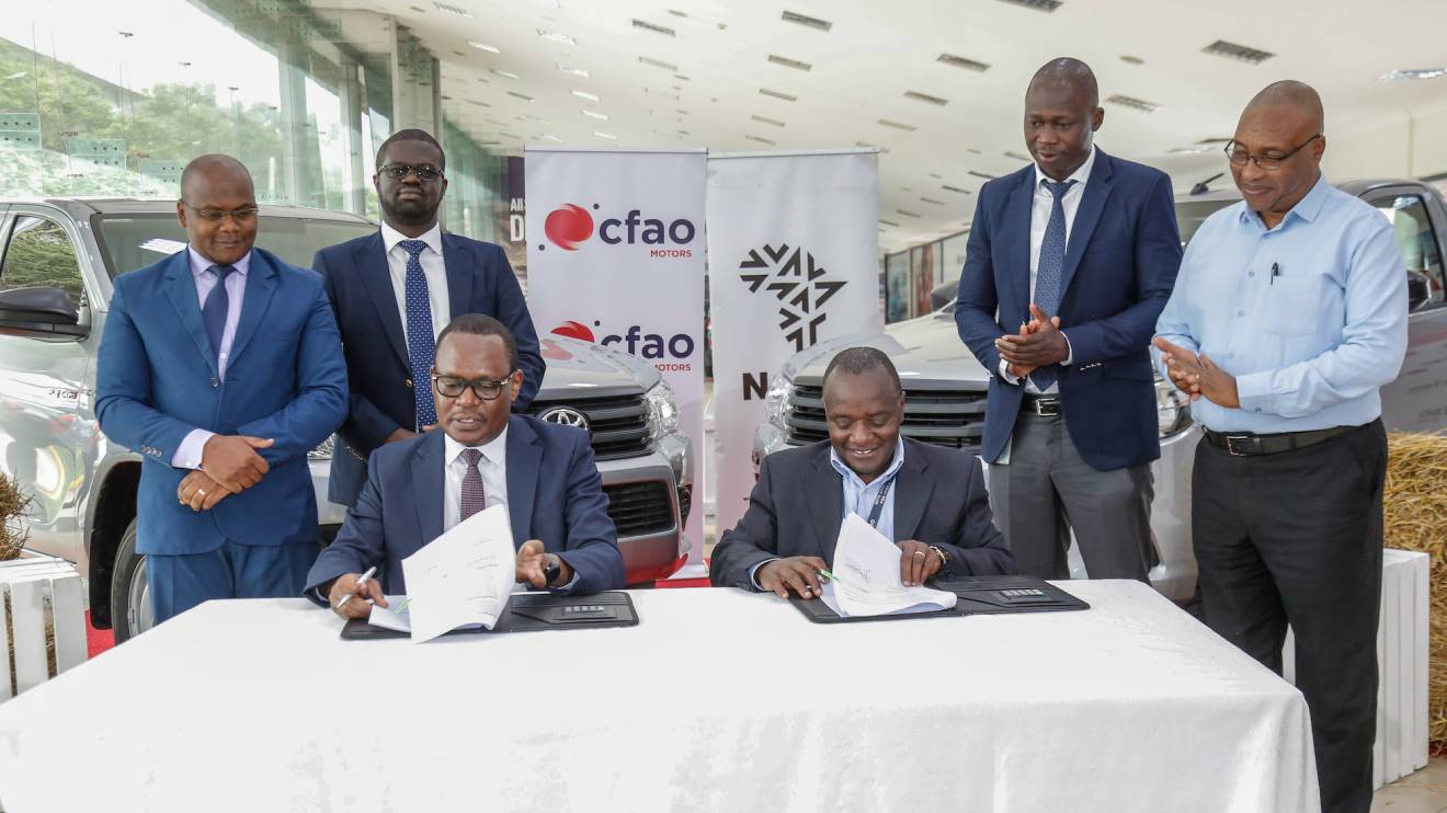 NCBA Group Director Asset Finance & Business Solutions, Mr. Lennox Mugambi (seated left), and CFAO Motors General Manager Sales, Mr. Daniel Maundu (seated right) sign the MoU between CFAO Motors and NCBA. PHOTO/COURTESY